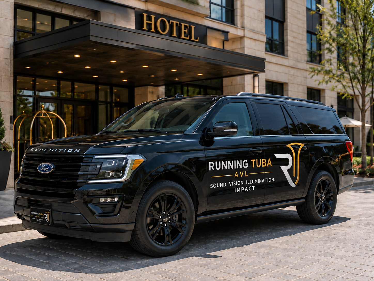 Branded Running Tuba AVL Expedition parked at a hotel entrance